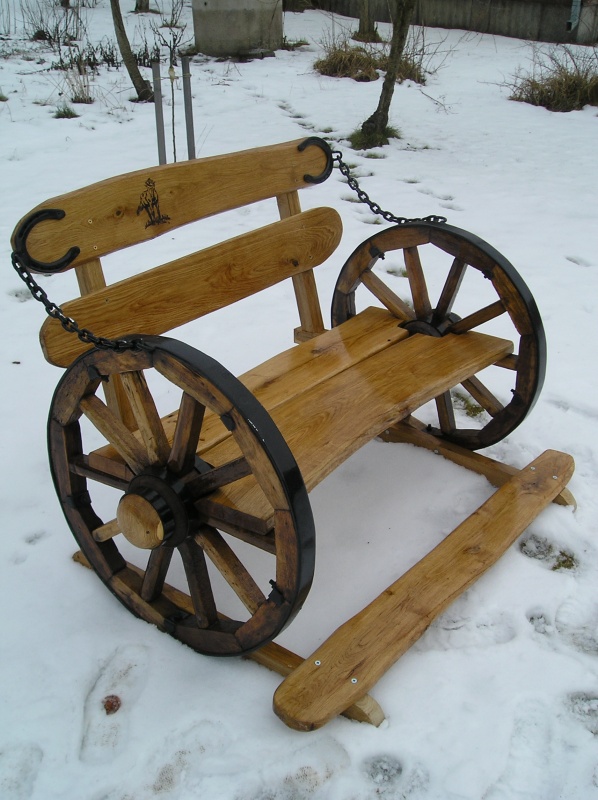 Outdoor bench with a chariot wheel