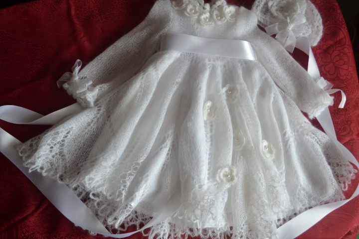 in baptism dress with cap