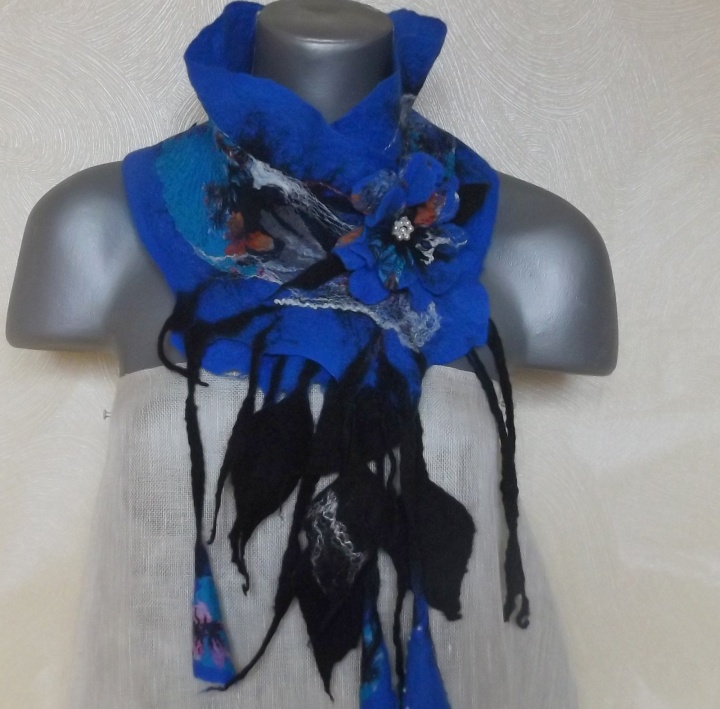 felting processes scarf with a blue brooch