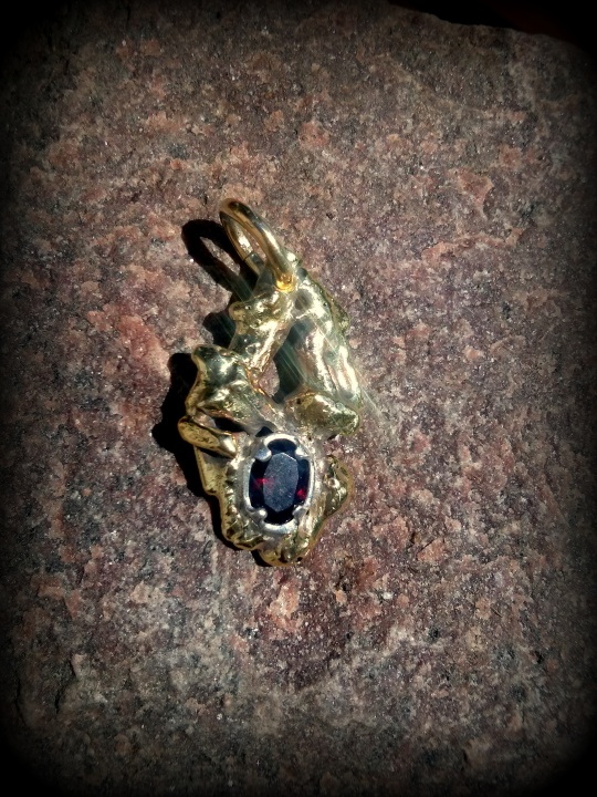 Pendant of silver and brass, with natural granate