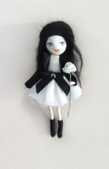 Doll brooch with vhite rose