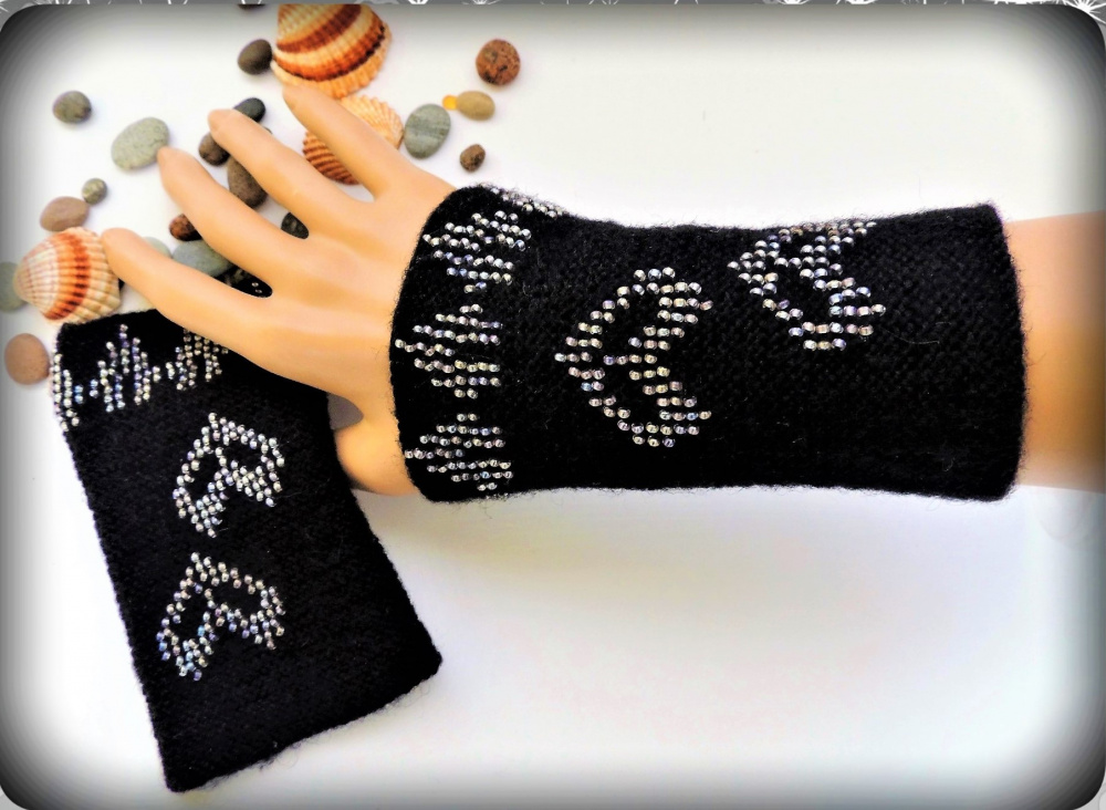 Hand-knitted black wristbands with beads.
