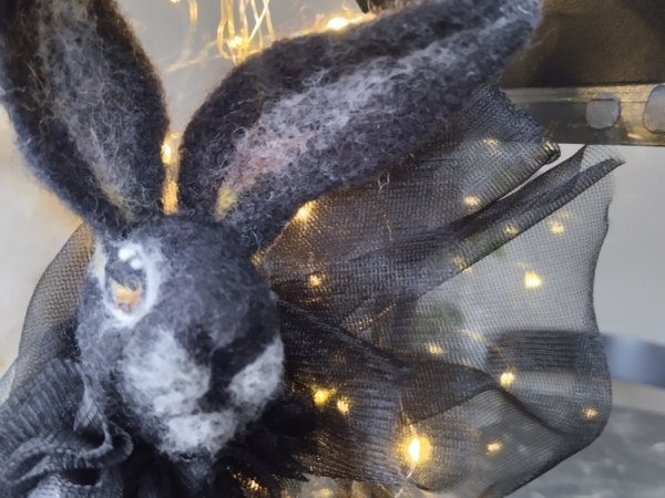 Souvenir Black Rabbit symbol of 2023, in vain by dry method.consists of: rabbit, chair, light bulbs, metal lantern.the rabbit is dressed in tulle   2